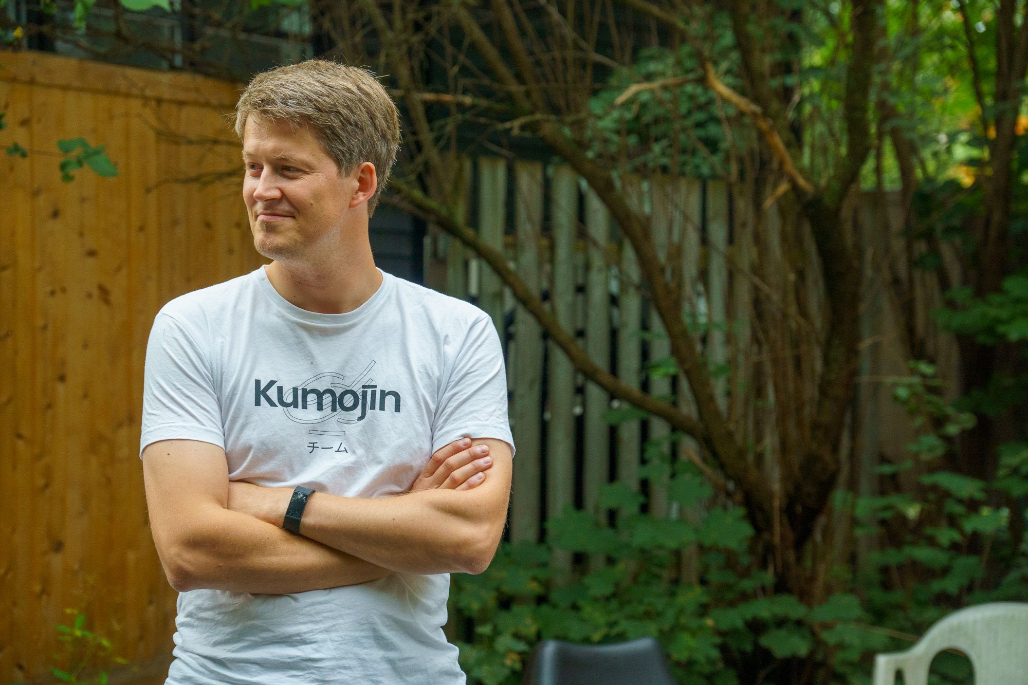 Lukasz Kokot looking away with his arm crossed